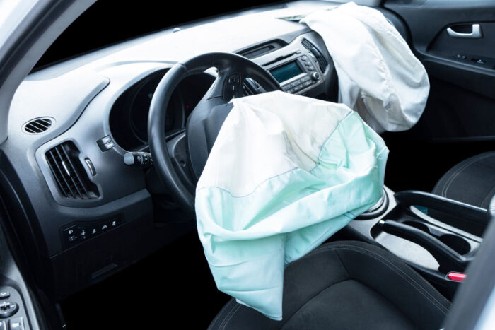 Interior of a vehicle with exposed airbags that triggered in an automobile accident.