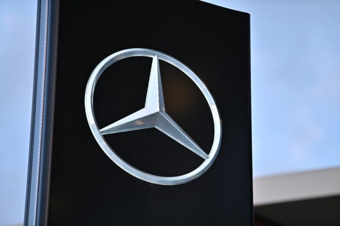 Sign with the logo of German car brand Mercedes-Benz at a dealership