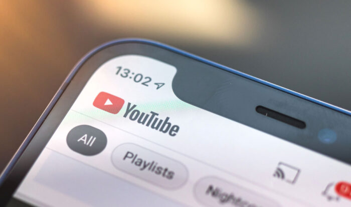 Close up of YouTube logo on app home screen displayed on a smartphone.