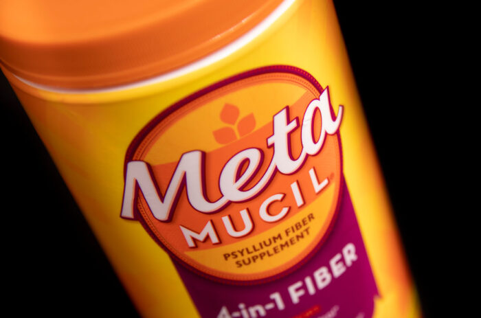 Product photo of Metamucil container against a black background.