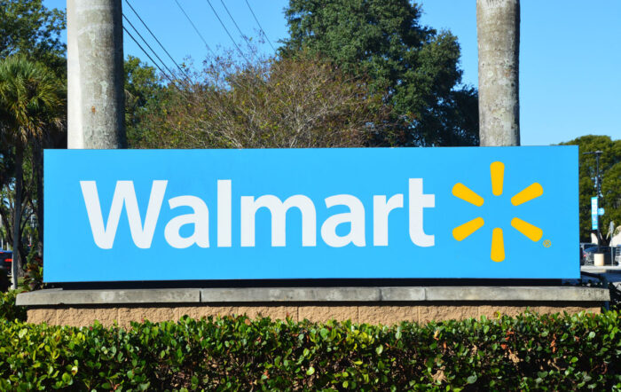 Close up of Walmart signage against foliage - walmart class action lawsuit
