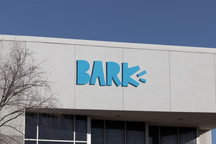 Close up of Bark signage, the parent company of Barkbox, on exterior of building against a blue sky.