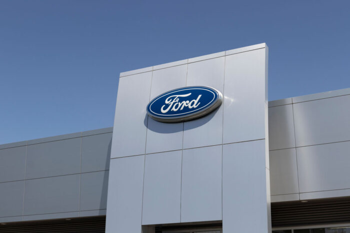 Ford signage on exterior of building against a blue sky.