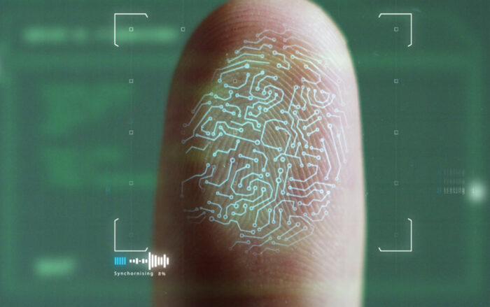 Close up of a thumb with a fingerprint scanning overlay - kronos fingerprint time clocks class action lawsuit settlement