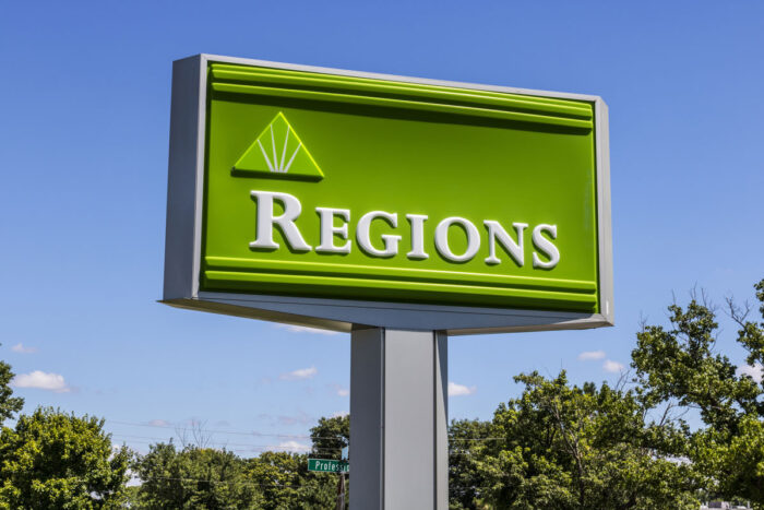 Regions Bank signage against a blue sky.