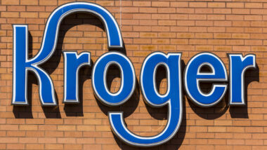 Close up of Kroger signage on a brick wall.