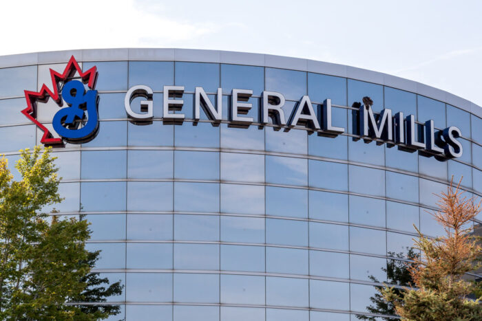 General Mills signage on exterior of a glass building against a blue sky.