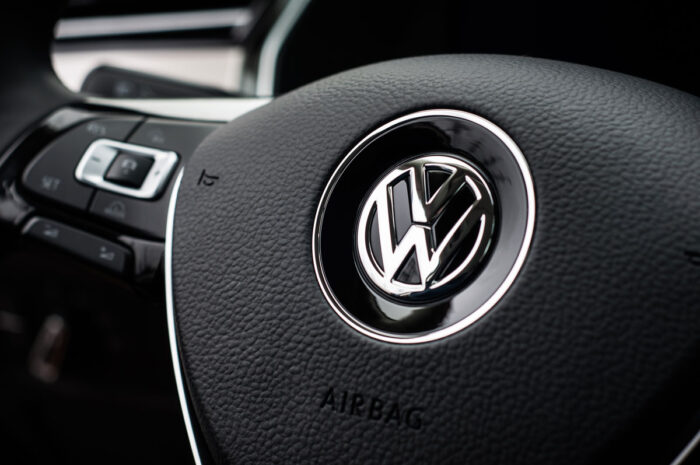 Volkswagen close up logo on steering wheel.