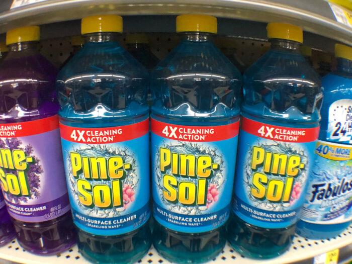 Close up of Pine-Sol bottles on a grocery store shelf.