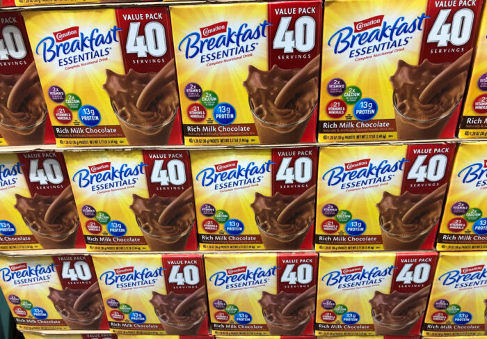 Boxes of chocolate Carnation Instant Breakfast Essentials by Nestle on sale at a Costco Warehouse store.