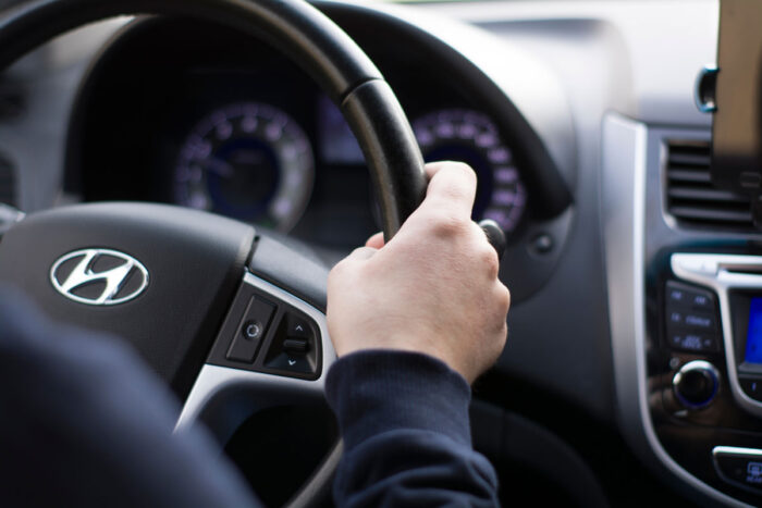 Close up of hands on a Hyundai steering wheel - Hyundai class action, lease