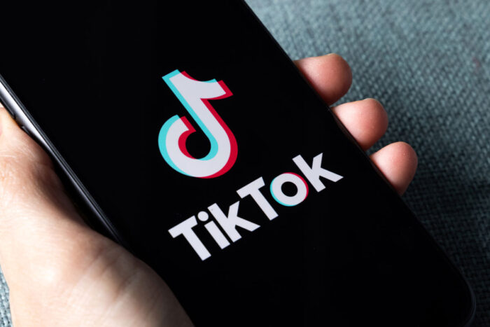 TikTok application icon on Apple iPhone 11 screen close-up - location data privacy