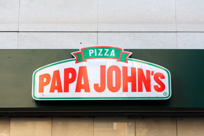 Close up of Papa John's signage on exterior of building.
