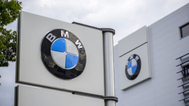 Close up of BMW signage against a blue sky.