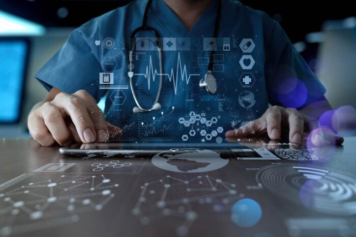 A medical professional using a keyboard with a data overlay. Healthcare data breach concept - LifeBridge lawsuit, lifebridge health data class action, lbh settlement