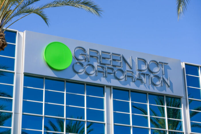 Close up of Green Dot signage on exterior of building against a blue sky - green dot class action lawsuit
