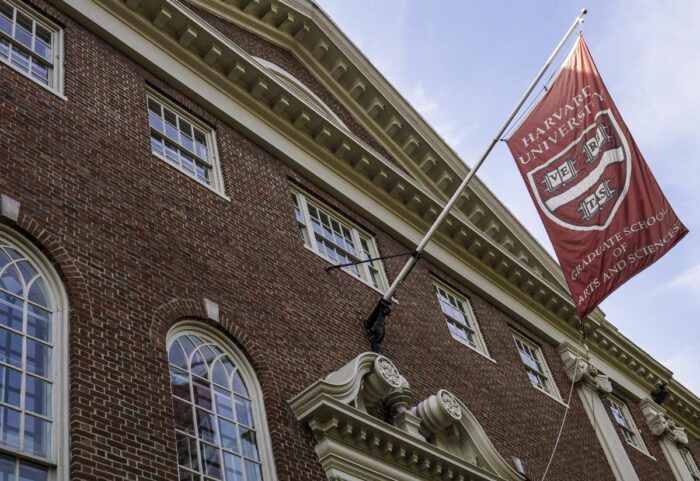 The architecture of the famous Harvard University in Cambridge, MA, USA with its brick buildings and banners.
