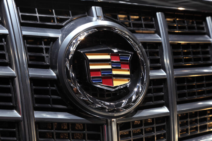 Close up of a Cadillac emblem on the grill of a vehicle.