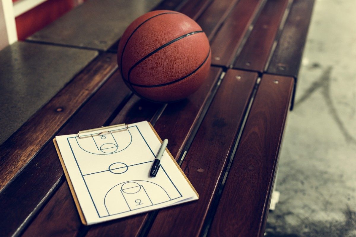 A basketball and court diagram sit on a bench, representing the Iowa Barnstormers coach Greg Stephen sexual abuse settlement