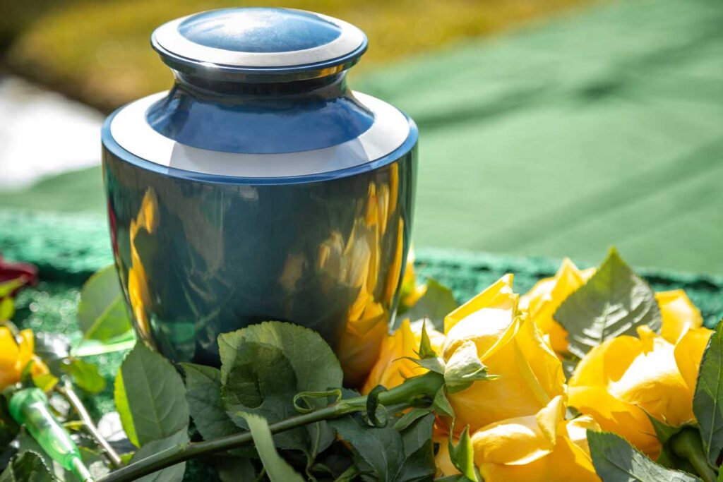 Close up of an urn and yellow roses, representing the Neptune Society and NCS Marketing Services false advertising class action lawsuit settlement.