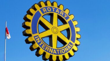 Rotary International sign against a blue sky.
