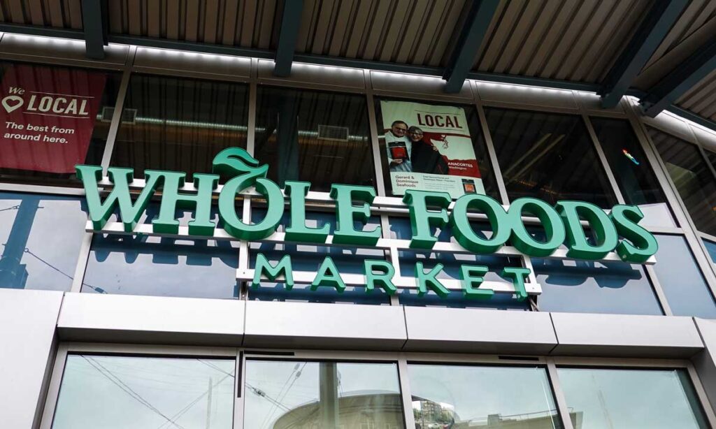 Close up of Whole Foods signage about its entrance.