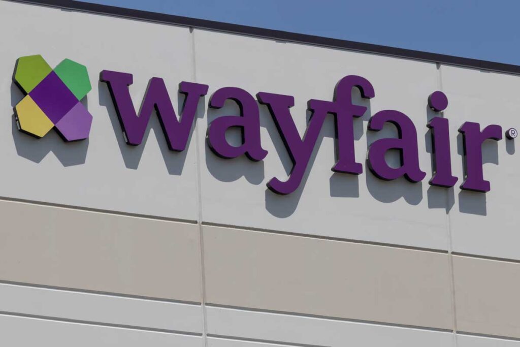 Close up of Wayfair signage against a blue sky.