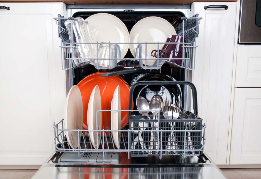 Close up of cookware inside of a dishwasher, representing the All-Clad ‘dishwasher safe’ false advertising class action settlement. Putting the product through a dishwasher can allegedly leave sharp edges.