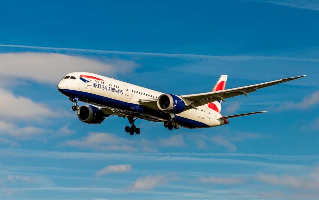 A British Airways plane in flight in the sky.