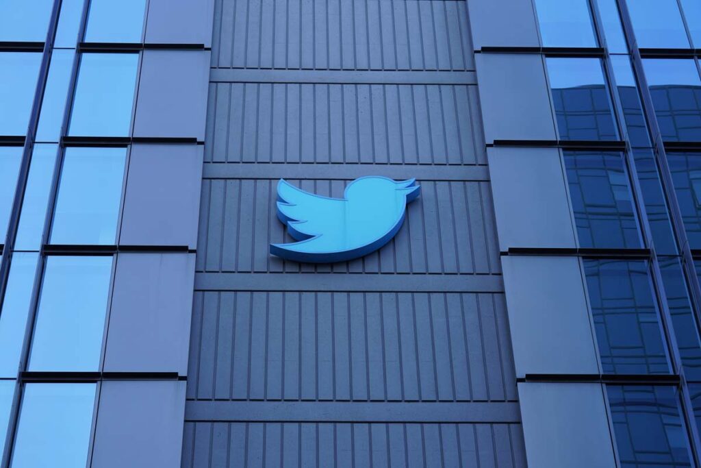 Twitter logo on exterior of a building  - Twitter layoffs class action