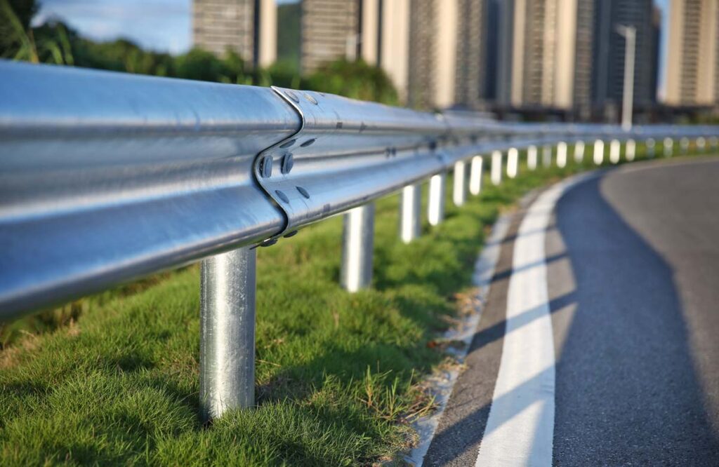 Close up of a traffic guardrail next to a road, representing Trinity Industries ET-Plus guardrails settlement.