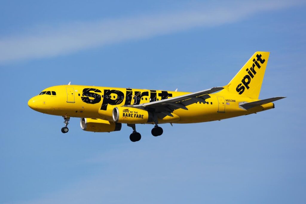 Close up of Spirit airlines plane flying in the air - website class action