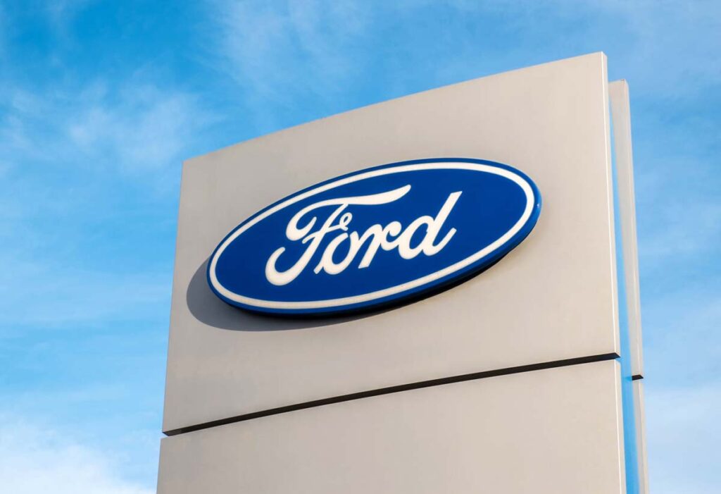 Ford dealership sign against a blue sky.