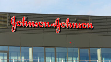 Johnson & Johnson company logo on headquarters building against a blue sky.