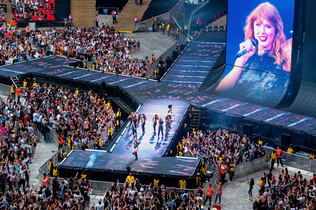 Taylor Swift performing at a concert, representing the Ticketmaster fees class action