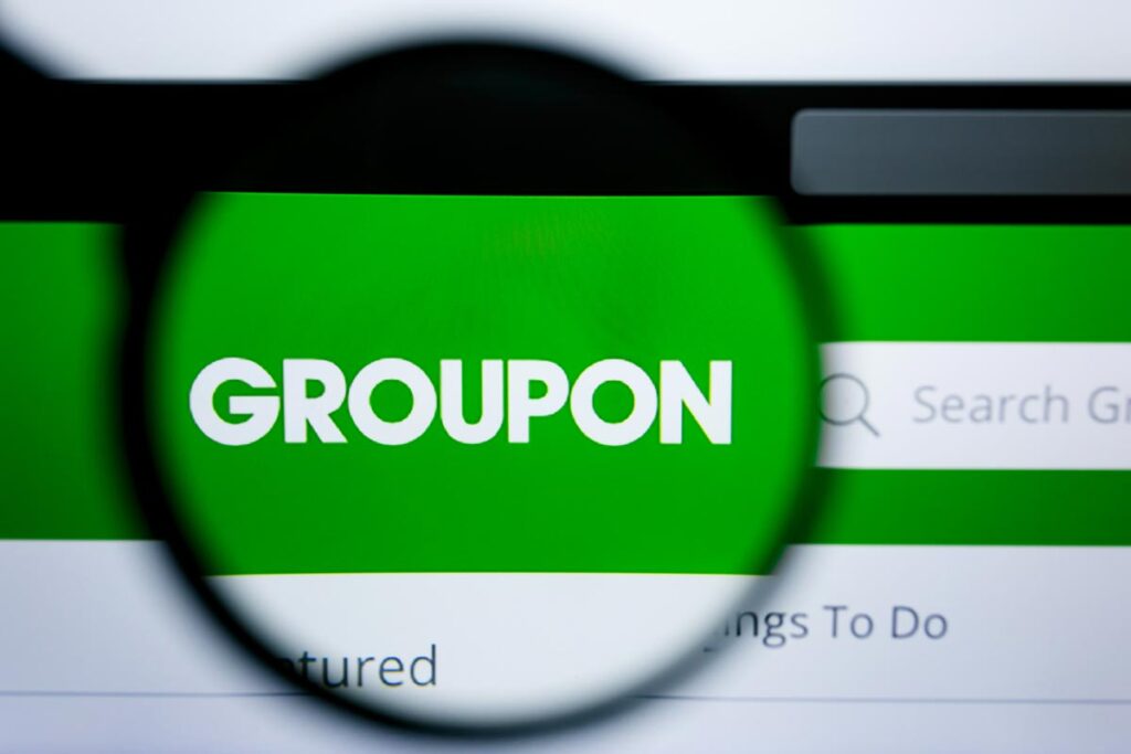 Close up of Groupon logo displayed on a screen.