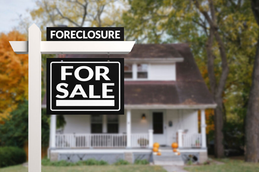 Close up of a foreclosure sign in front of a house, representing the Oakland County foreclosure profits settlement.