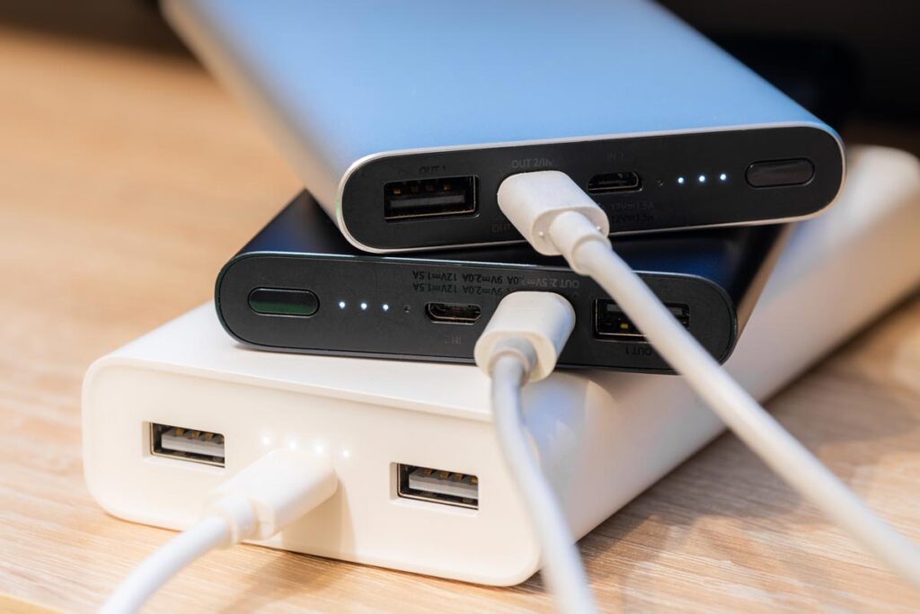 Close up of portable battery packs on a wood table.