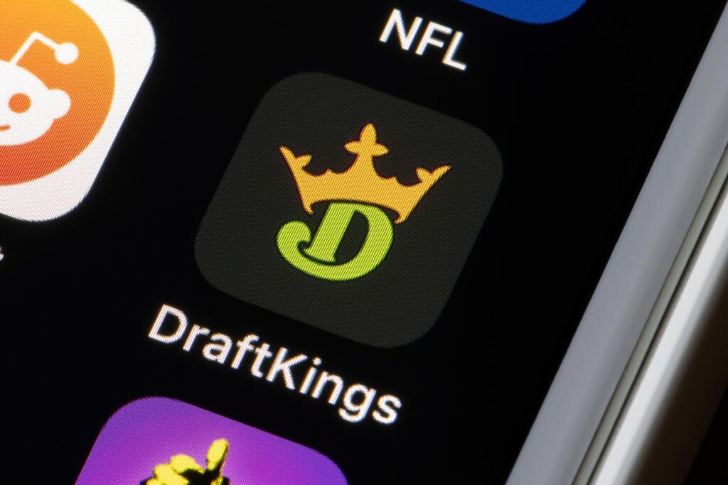 Close up of Draft Kings app icon displayed on a smartphone screen.