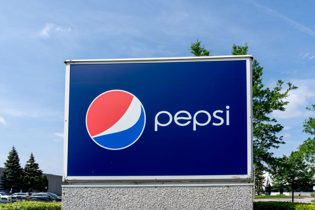 Close up of Pepsi signage against a blue sky.