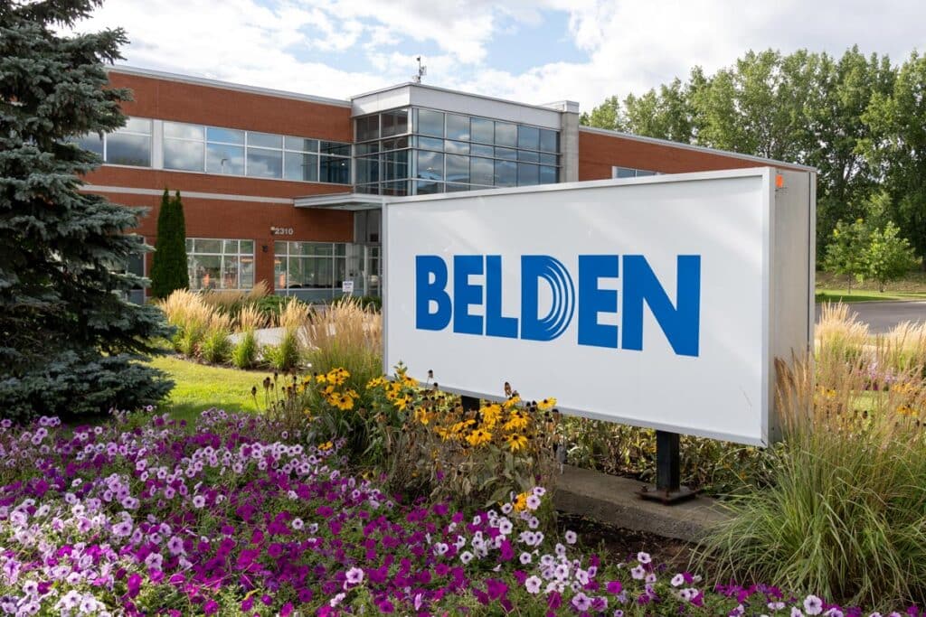 Close up of Belden signage in a garden.