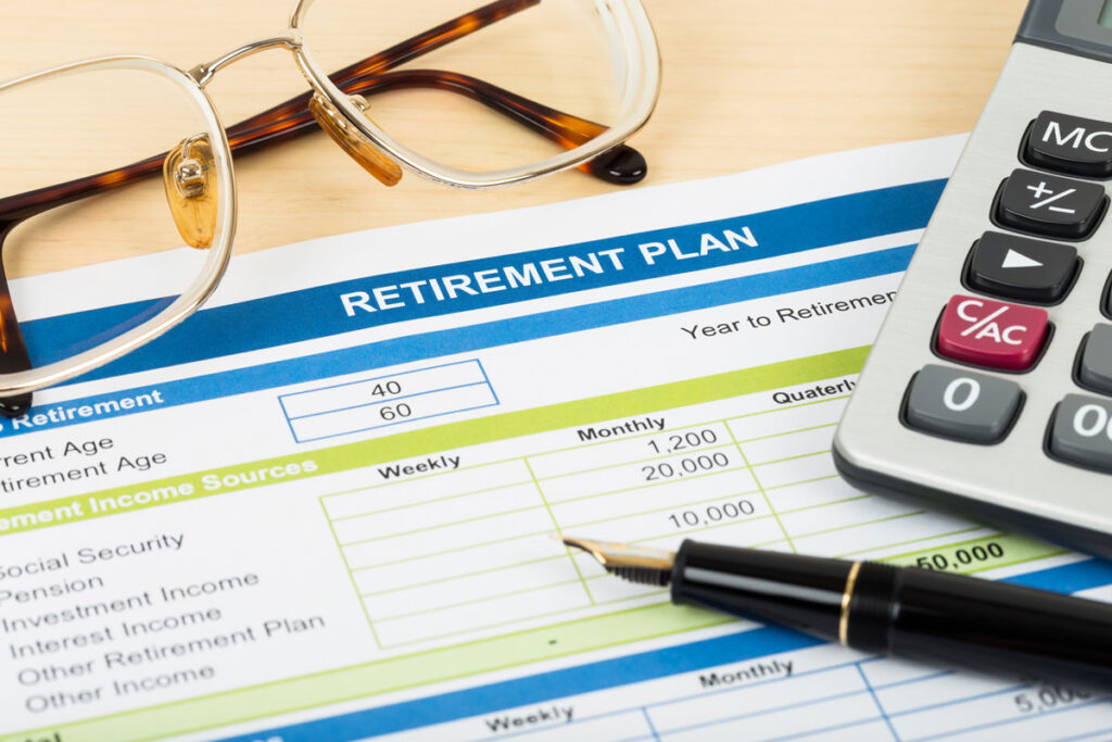 Retirement plan with glasses, pen, and calculator, representing the L Brands 401(k) fees class action lawsuit settlement.