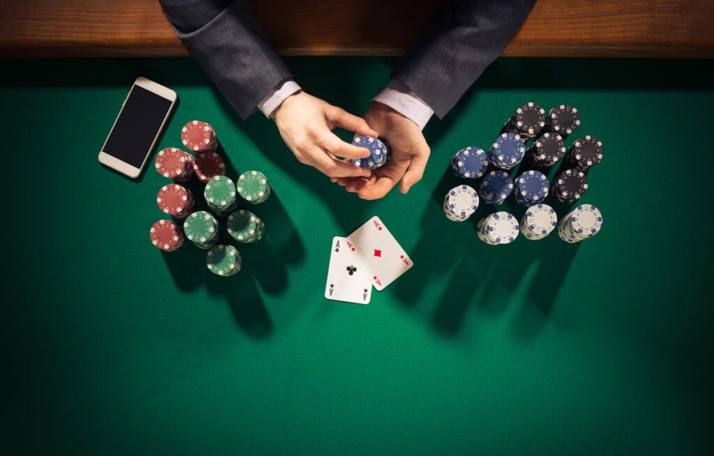 Top view of a poker player holding chips, representing the Par-A-Dice Illinois class action lawsuit settlement.