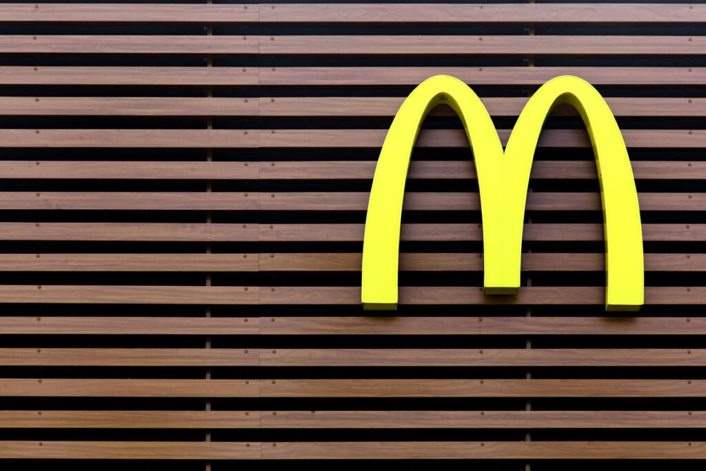 McDonald's logo on a striped facade, representing the McDonald’s COBRA class action settlement.