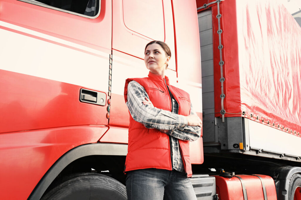 Female trucker in front of her semi.