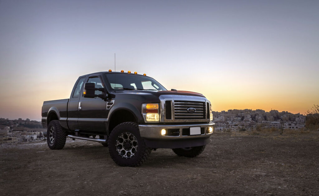 Ford Super Duty truck against a sunset sky.