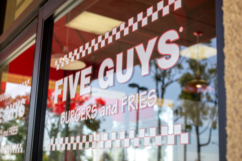 Close up of Five Guys window signage.