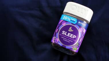 Olly Sleep gummies resting on a pillow.