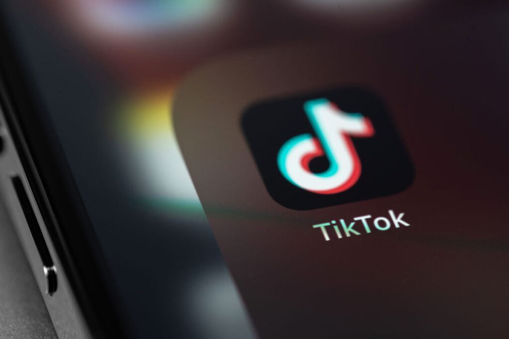 Close up of Tik Tok app icon on a smartphone screen - TikTok ruling, death