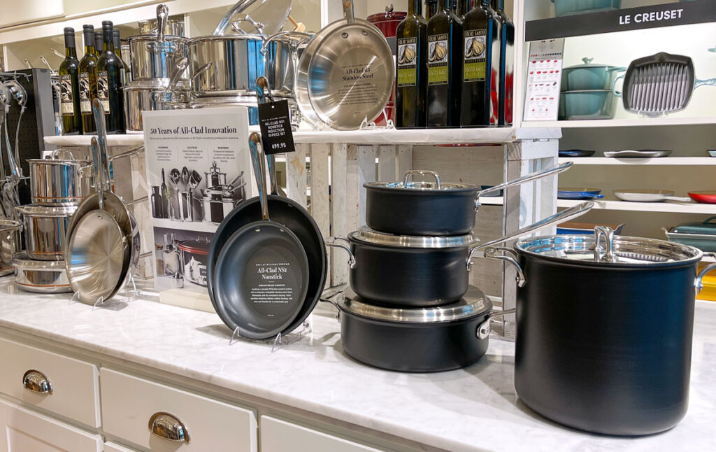 The Nonstick All Clad pot and pan aisle at a Williams Sonoma store at an indoor mall.